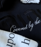 Back view of The Covering Hoodie with יהוה embroidery and white cursive "Covered by the Most High" declaration.